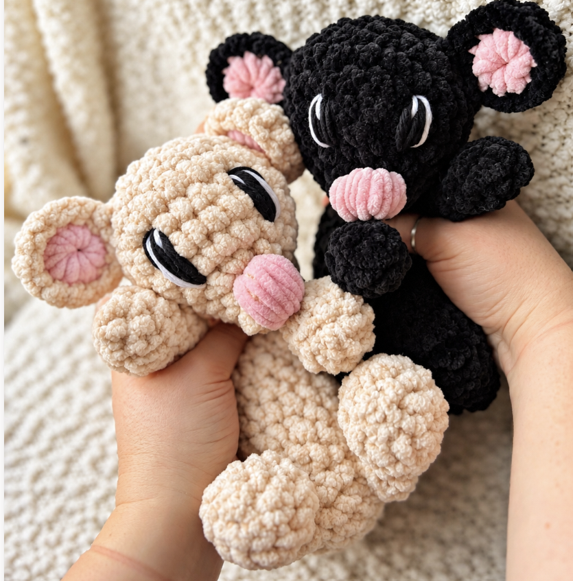 Juniper the Bloom Spirit, a coral-pink crocheted dragon with a yellow flower on her forehead